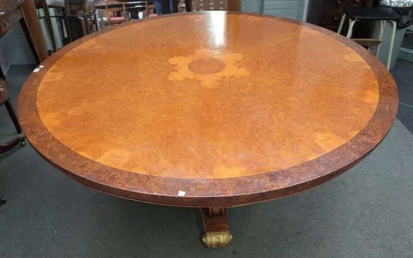 A Regency style pollard oak circular dining table, on three downswept supports and gilt scroll feet, 168cm diameter x 75cm high.