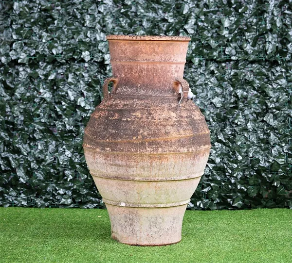 A large terracotta oil jar, with ribbed body and three lug handles, 100cm high x 50cm diameter.