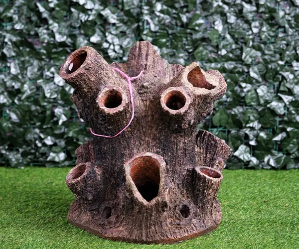 A terracotta strawberry planter of naturalistic tree trunk form, 53cm high.