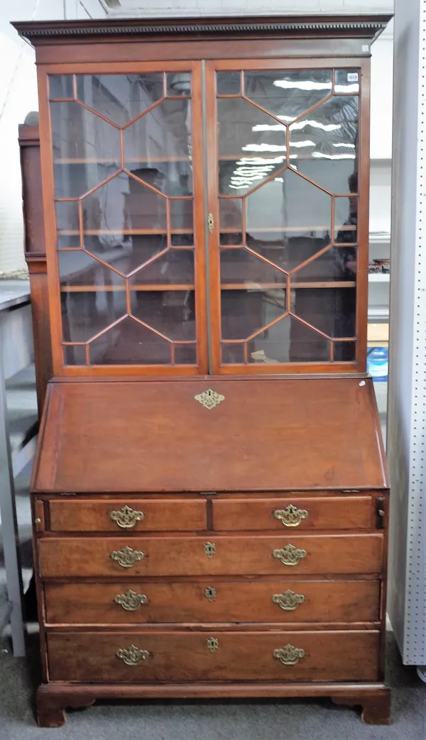 A George III mahogany bureau bookcase, the pair of glazed doors over fitted interior, with two short and three long graduated drawers on bracket feet,