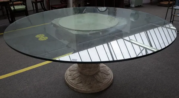 A 20th century dining table, the circular glass top on a distressed white painted reconstituted stone Greek revival column capital, 160cm diameter x 7