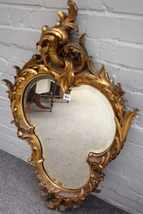 An early 20th century gilt framed trefoil shaped wall mirror with 'C' scroll crest, 60cm wide x 104cm high together with two similar mirrors, 37cm wid