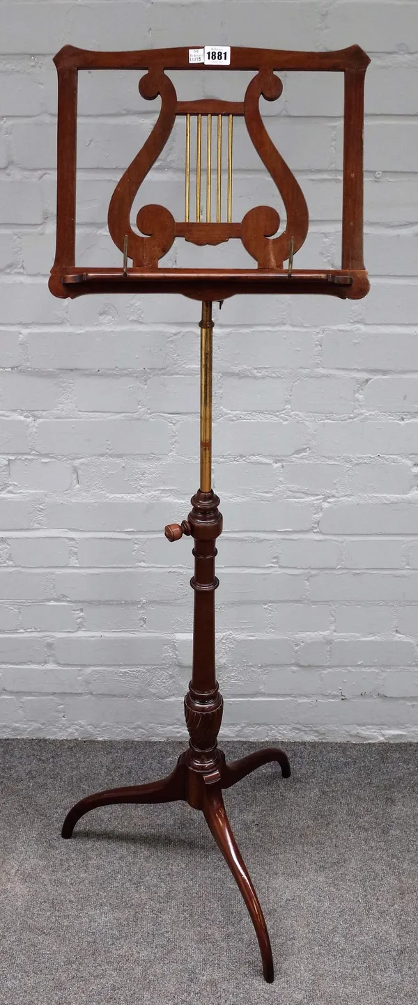 A late 19th century mahogany height adjustable music stand, with lyre decoration and tripod base 40cm wide.