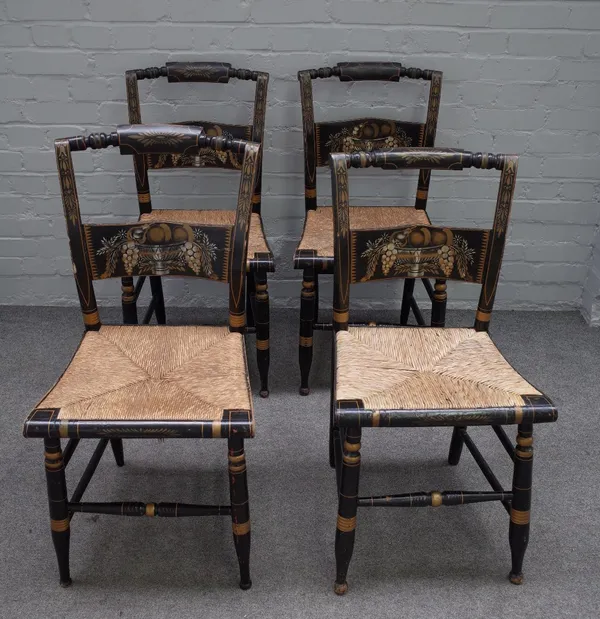 Probably Hitchcocksville chairs; four dining chairs of 19th century parcel gilt, ebonised rush seated chairs on turned supports, 45cm wide x 87cm high