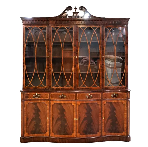 A George III style mahogany breakfront bookcase cabinet, the four astra glazed doors over four drawers and cupboards on a plinth base, 184cm wide x 22