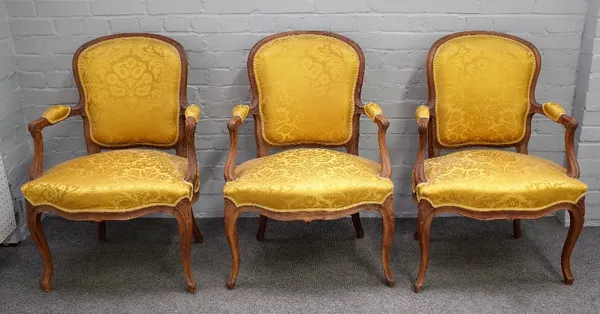 A set of three 18th century style French stained beech open armchairs with serpentine seat on cabriole supports, 65cm wide x 92cm high.