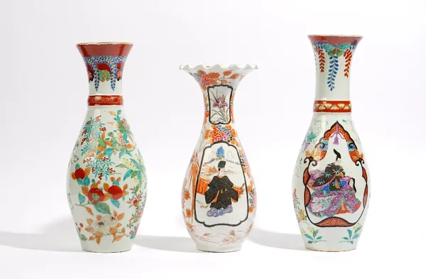 Two Japanese Imari vases, Meiji/ Taisho period, of similar slender baluster form, each painted with a basket of flowers, one vase with a panel painted