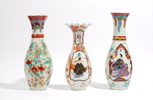 Two Japanese Imari vases, Meiji/ Taisho period, of similar slender baluster form, each painted with a basket of flowers, one vase with a panel painted