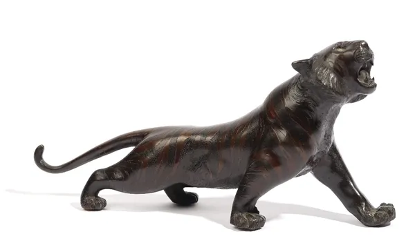 A Japanese bronze figure of a prowling tiger, 20th century, signed, 29cm. length.