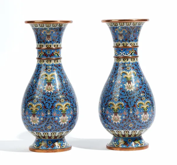 A pair of Chinese cloisonné vases, 20th century, of slender pear form, worked with lotus flowers and foliage against a blue ground, 31cm. high; and an