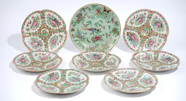 Seven Canton famille-rose plates, late 19th century, of quatrelobed form, each painted with panels of birds, insects, fruit and flowers, 22cm. diamete