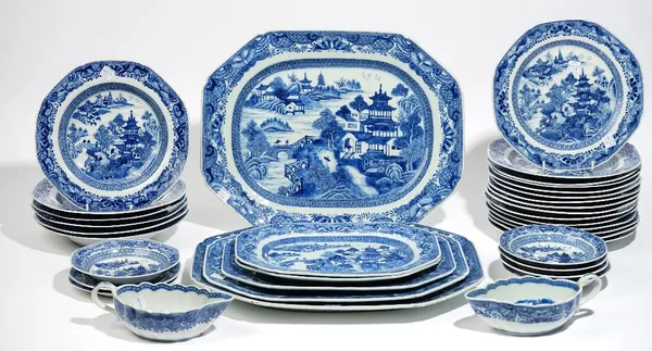 A Chinese export blue and white part service, late 18th/early 19th century, each piece painted with figures and buildings in a river landscape inside