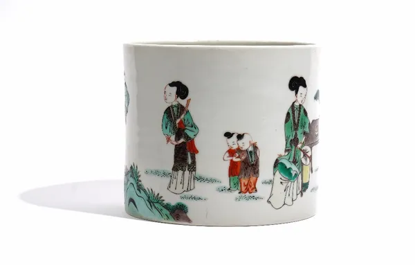 A Chinese famille-verte cylindrical brush pot. 19th century, painted with two women and boys at leisure, 15cm. high by 17cm. diameter.