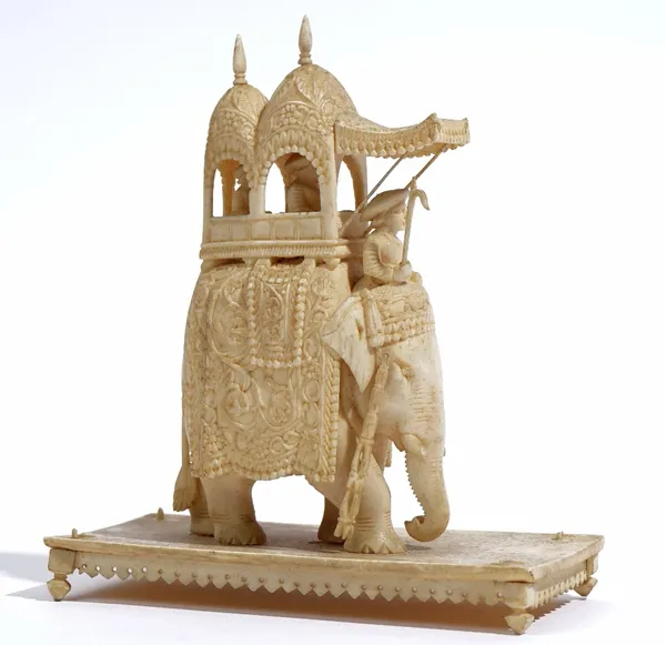 A group of ivory carvings, 19th century, comprising; a group of an elephant with howdah and four attendants, 15cm high, a Chinese carved ivory handle,