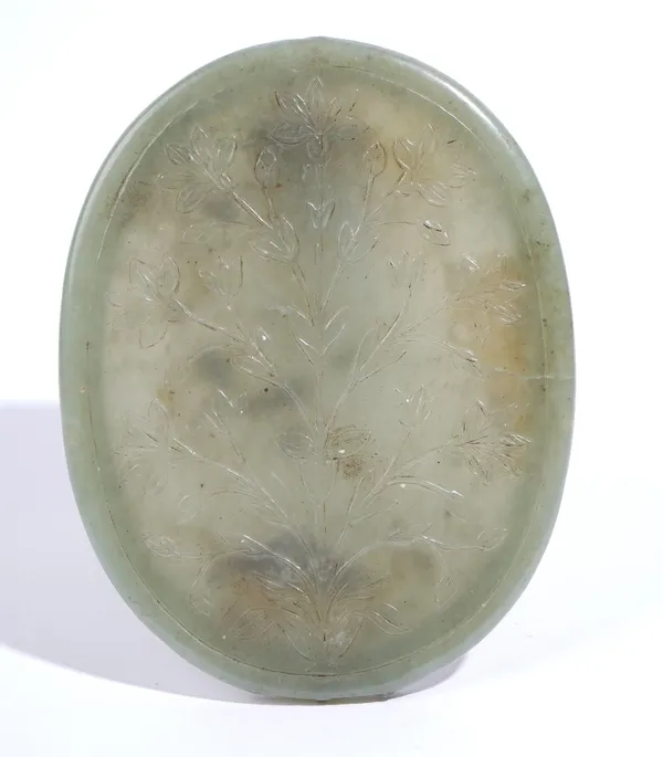 A celadon jade oval mirror frame, probably Mughal India, 18th/19th century, the back carved in low relief with a flowering plant, the stone of olive t