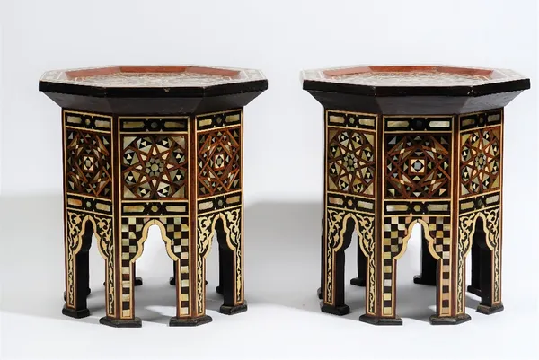 A pair of small Ottoman style octagonal occasional tables, each inlaid with mother-of-pearl, 32cm. high, (2).