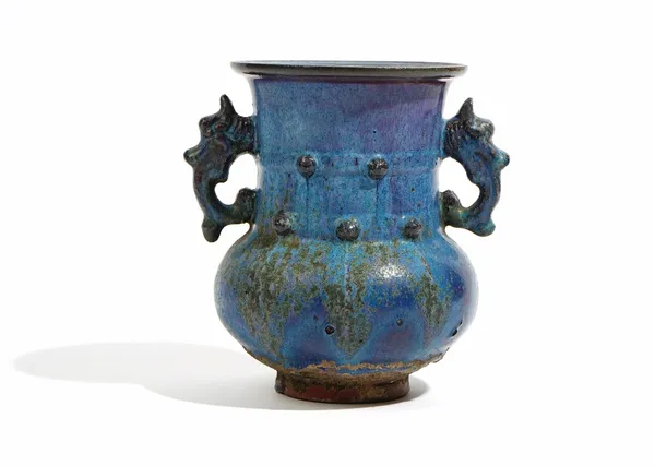 A Chinese pottery two-handled vase, probably late 19th/20th century, set with dragon mask handles and covered in a blue and purple streaked glaze, 17c