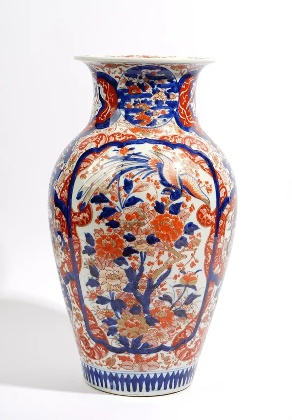 A tall Japanese Imari vase, Meiji period, painted with two large panels of ho-o birds amongst flowering shrubs and smaller panels of flowers and drago