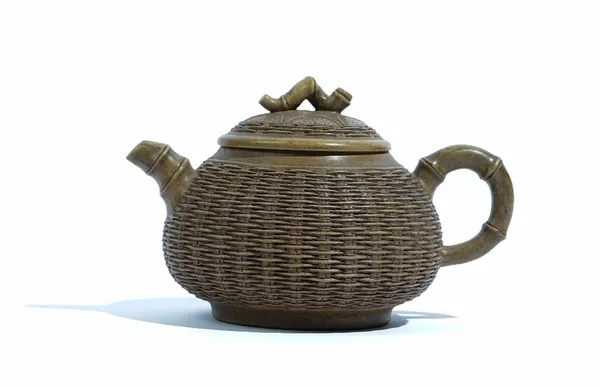 A Chinese Yixing teapot and cover, the compressed body moulded with basketwork, set with bamboo spout, handle and knop, stamped marks, 10cm. high, (2)