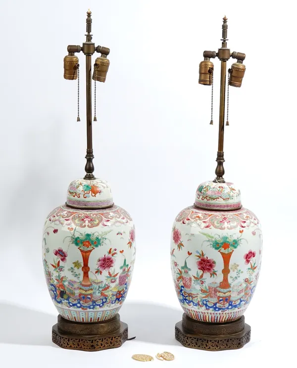 A pair of Chinese famille-rose oviform vases and covers adapted as lamps, late 19th century, each painted with vases, tables, flowers and insects, ins