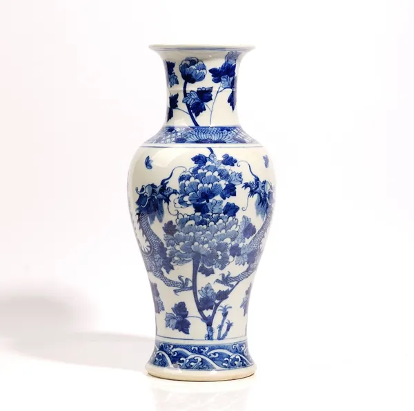 A Chinese blue and white baluster vase, late 19th century, painted with two confronting dragons amongst peonies, four character Kangxi marks, 38.5cm.