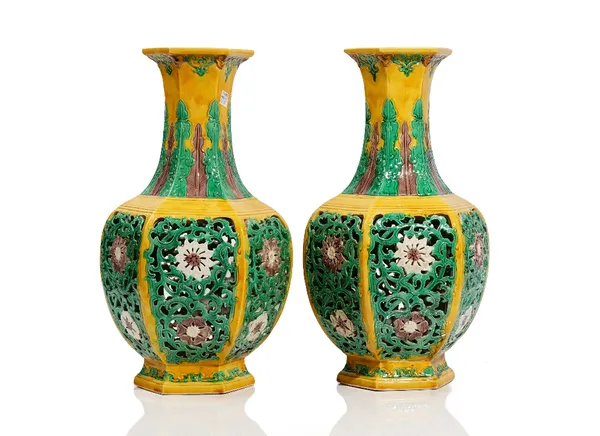 A pair of Chinese yellow ground hexagonal vases, impressed Qianlong seal marks but later, each side pierced with lotus flowers and tendrils, the neck