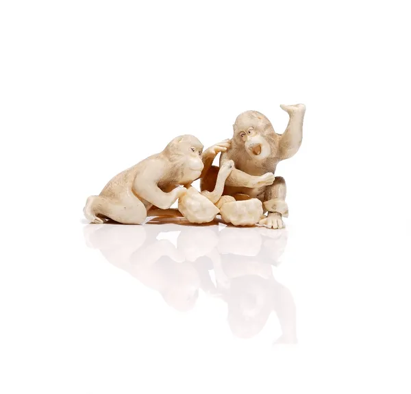 A Japanese ivory carving of two monkeys alarmed by a snake, Meiji period, unsigned, (a.f), 9cm. length; and an ivory carving of a seated man with fish