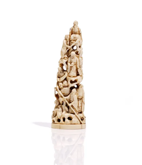 A Japanese ivory group, Meiji period, carved in the round  as a tower of figures, unsigned, 16cm. high.Weight 179gms.