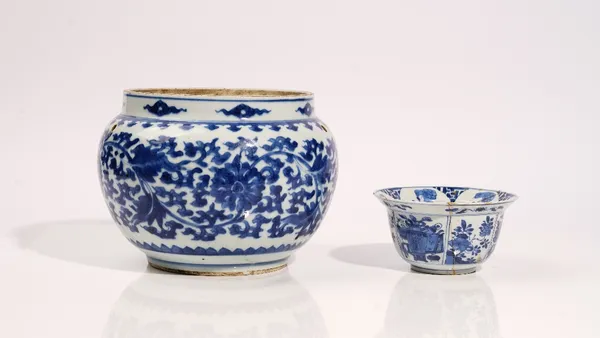 A Chinese blue and white bowl, 17th/18th century, painted with lotus flowers and tendrils, the shoulders pierced each side with two holes, 17cm. high