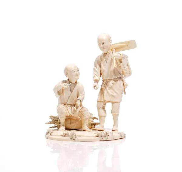 A Japanese sectional ivory okimono of two farmers, Meiji period, one standing carrying an adze, a basket across his back, the other seated on a bundle