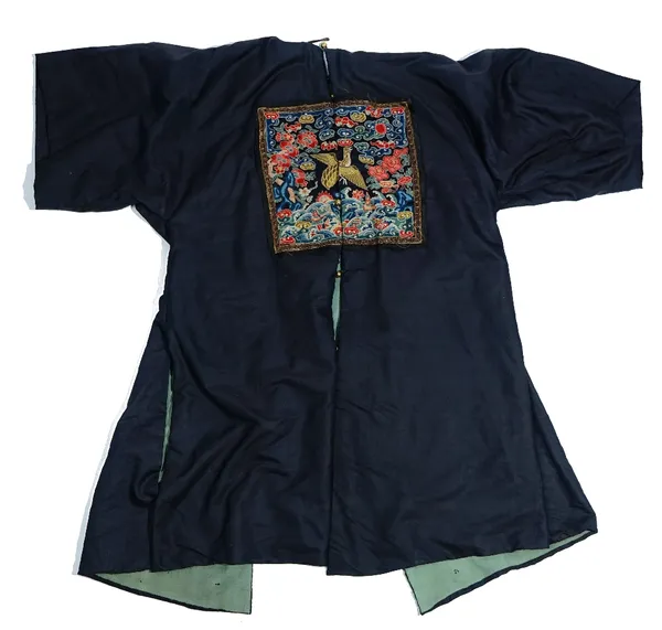 A Chinese embroidered surcoat, late 19th century, of dark navy satin, each side embroidered with a rank badge of a quail of the eighth civil rank.