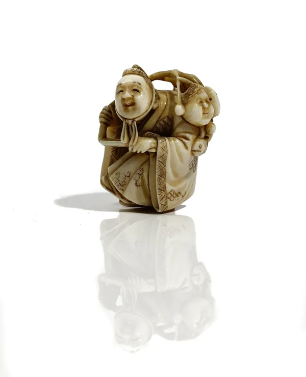 A Japanese ivory netsuke, Meiji period, carved as a trinket sale carrying his wares over his shoulder, signed on red lacquer tablet, 4.5cm. high.