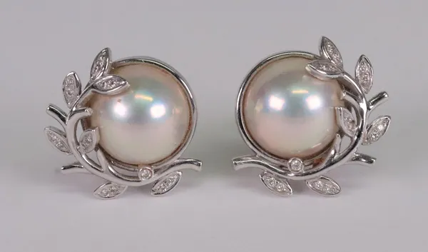 A pair of mabé pearl, 18ct white gold and diamond set earclips, the central mabé pearl in a white gold mounts designed as leaf sprays, each set with c