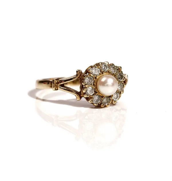 A 9ct gold, diamond and cultured pearl cluster ring, mounted with the single cultured pearl within a surround of ten circular cut diamonds, between sp