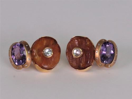 A pair of amethyst, amber and diamond set pendant earrings, the oval amber beads set with a rose cut diamond to the centre suspending an oval mixed cu