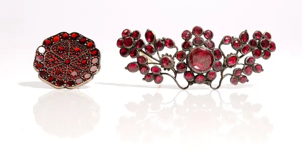 A garnet brooch, in a dished hexafoil design and a foil backed garnet brooch, designed as a spray, (2).