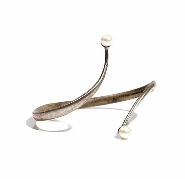 A Georg Jensen Torun silver and cultured pearl bangle, in a twistover design, mounted with a cultured pearl at each end, detailed Georg Jensen 925 S D