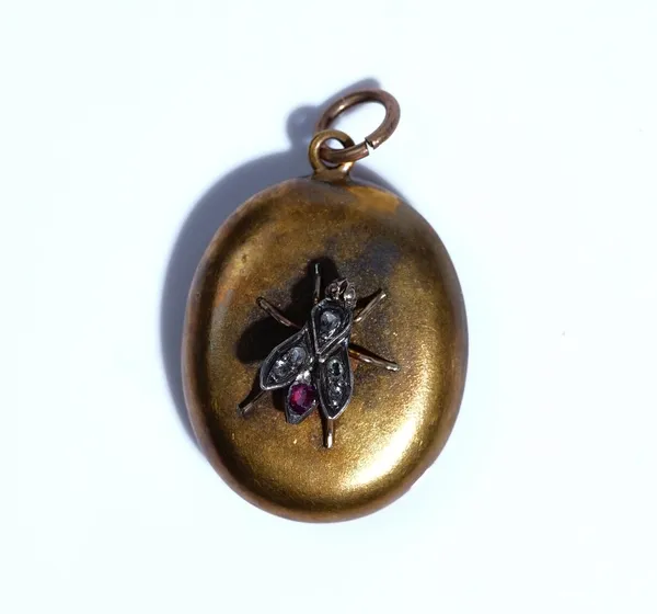 A Victorian gold, diamond and ruby set oval pendant locket, the front with a fly motif, set with rose diamonds (one rose diamond lacking) and with a c