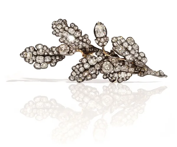 A diamond brooch, first half of the 19th century, designed as a spray of oak leaves with acorns, mounted with cushion shaped diamonds, length 6.7cm, g