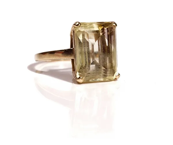 A 9ct gold ring, claw set with a rectangular step cut citrine, ring size P, gross weight 7.3 gms.