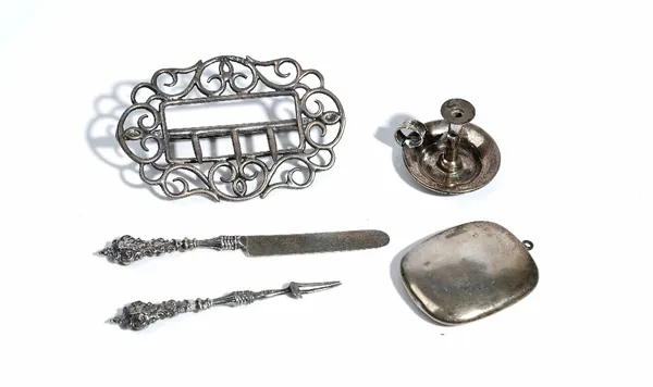 A late Victorian silver waist belt buckle, with scroll pierced decoration, Birmingham 1899, a silver pendant powder compact, Chester 1916, a silver mi