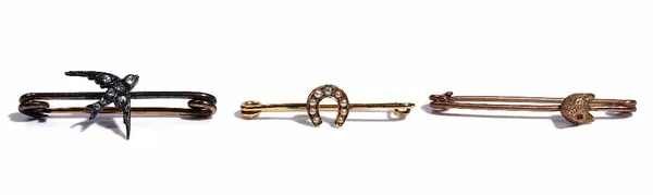 A rose diamond set bar brooch, with a swallow motif, a gold and seed pearl set bar brooch, with a horseshoe motif and a gold brooch, with a foxes mask