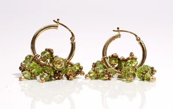 A pair of gold and faceted peridot bead earrings, each circular earring with faceted peridot bead drops, detailed 14 K, gross weight 11.6 gms.