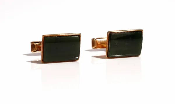 A pair of gold mounted New Zealand jade cufflinks, with curved rectangular fronts and with folding bar fittings at the backs, detailed 9 CT, combined