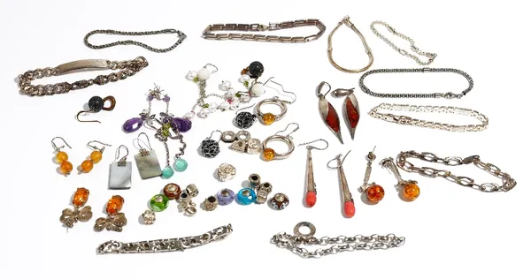 A group of mostly silver mounted jewellery, comprising; twelve pairs of earrings, nine bracelets, an identity bracelet and eighteen sliding beads for