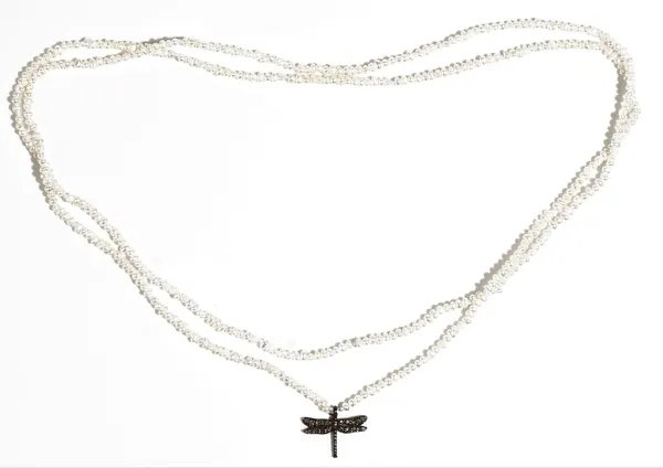 A single row necklace of freshwater seed pearls, the front with a diamond set dragonfly pendant, length 80cm.