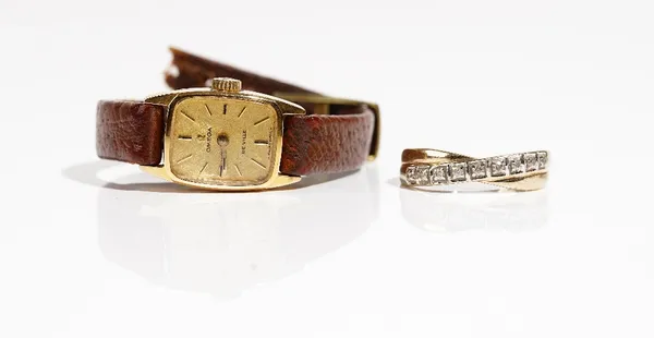 An Omega De Ville gilt metal fronted and steel backed lady's wristwatch and a 9ct gold and diamond ring, mounted with a row of nine circular cut diamo