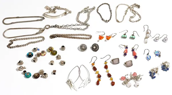 A group of mostly silver mounted jewellery, comprising; twelve pairs of earrings, nine bracelets, an identity bracelet and nineteen sliding beads for