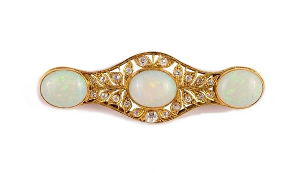 A gold, opal and diamond brooch, of shaped elliptical form, mounted with three oval opals, otherwise with pierced foliate decoration, mounted with cus