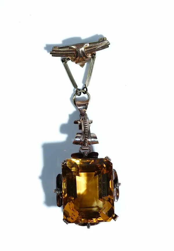 A gold and citrine single stone pendant, (the large cut cornered rectangular step cut citrine detached, but present), later fitted to a gilt metal bro